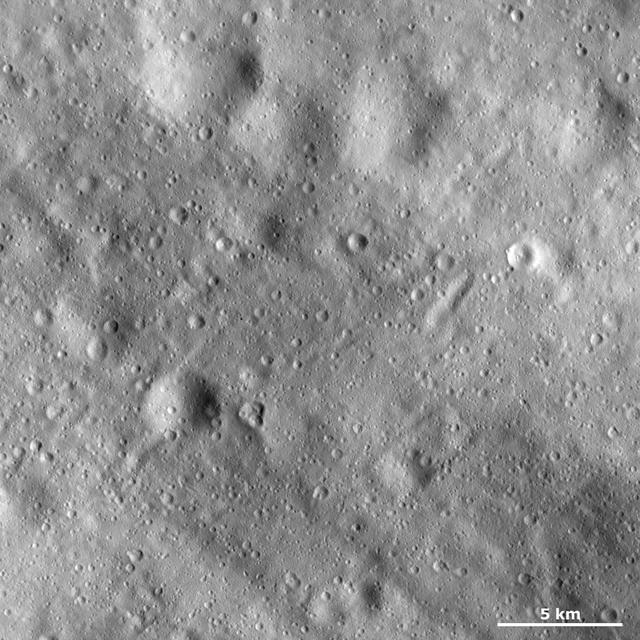 This image from NASA Dawn spacecraft shows many craters of different sizes and states of preservation on asteroid Vesta surface. In the top of the image there are four large, very degraded craters.