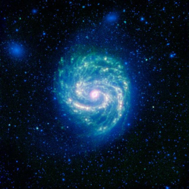 The galaxy Messier 100, or M100, shows its swirling spiral in this infrared image from NASA Spitzer Space Telescope. The arcing spiral arms of dust and gas that harbor star forming regions glow vividly when seen in the infrared.