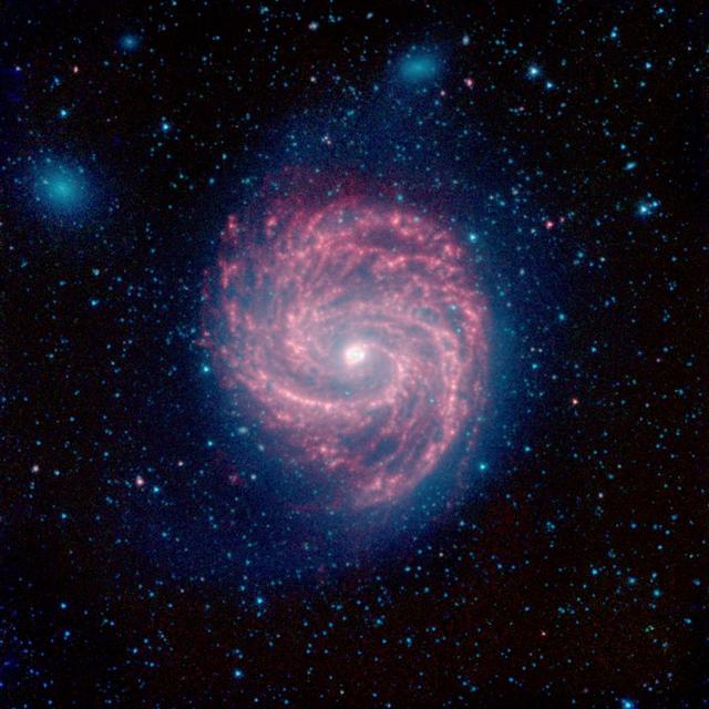 This infrared image, from NASA Spitzer Space Telescope, of M100 is a classic example of a grand design spiral galaxy, with prominent and well-defined spiral arms winding from the hot center, out to the cooler edges of the galaxy.