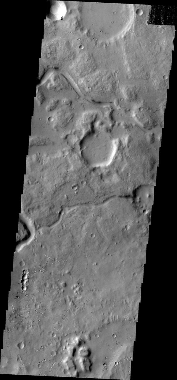 The channels in this image captured by NASA Mars Odyssey spacecraft are located between Ares Vallis, a large channel, and Siinka Vallis, a much smaller channel.