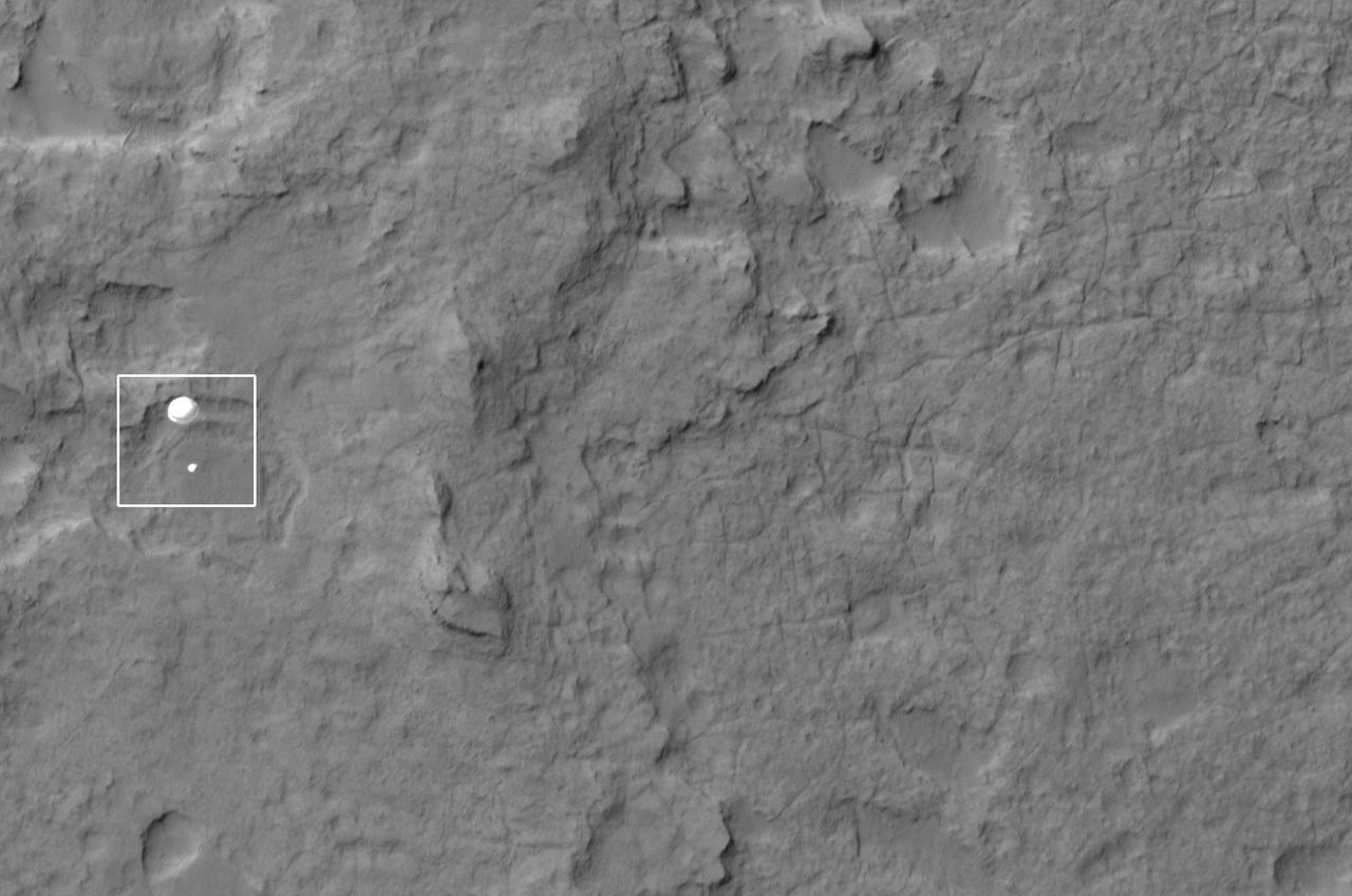 NASA Curiosity rover and its parachute were spotted by NASA Mars Reconnaissance Orbiter as Curiosity descended to the surface on Aug. 5 PDT Aug. 6 EDT. Curiosity and its parachute are in the center of the white box.