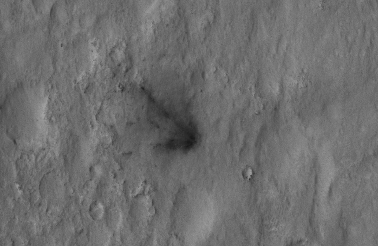 This close-up view captured by NASA Mars Reconnaissance Orbiter shows darkened radial jets caused by the impact of Curiosity sky crane, which helped deliver the rover to the surface of Mars.