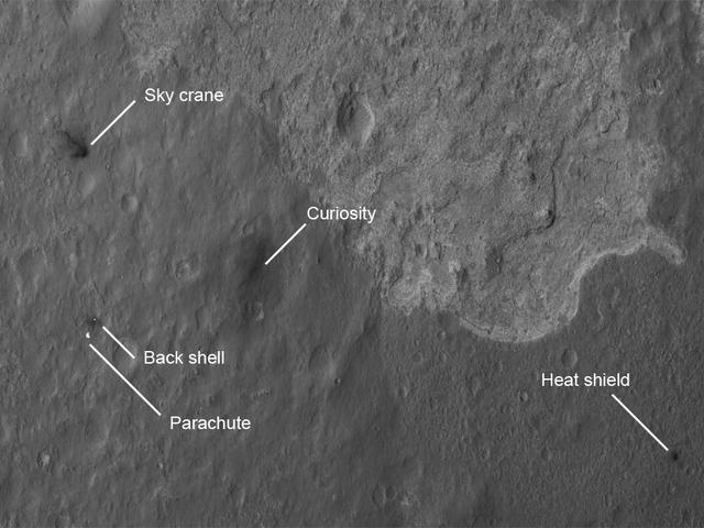The four main pieces of hardware that arrived on Mars with NASA Curiosity rover were spotted by NASA Mars Reconnaissance Orbiter MRO which captured this image about 24 hours after landing.