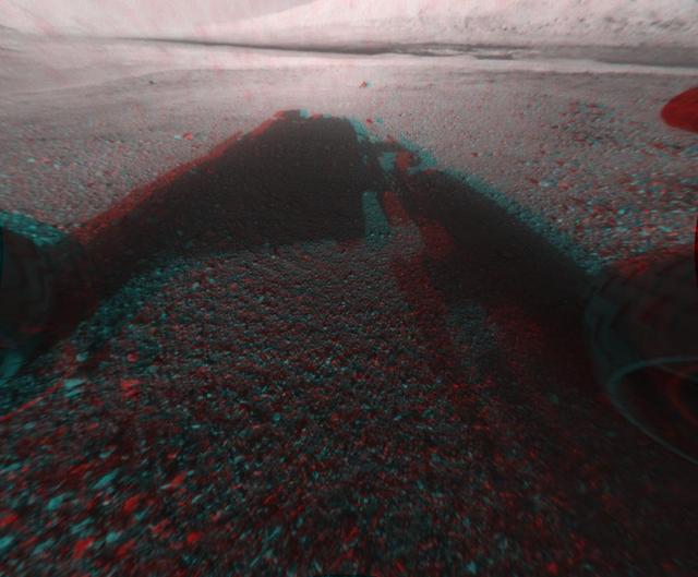 This image is a 3-D view in front of NASA Curiosity rover captured by the rover front left Hazard-Avoidance camera. The image is cropped but part of Mount Sharp is still visible rising above the terrain.
