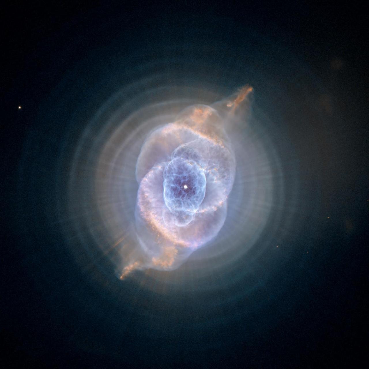 This detailed view of NGC 6543, the Cat Eye Nebula, from NASA Hubble Space Telescope includes intricate structures, including concentric gas shells, jets of high-speed gas, and unusual shock-induced knots of gas.