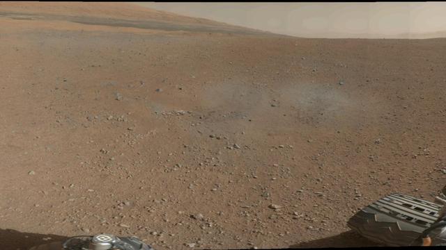 This is a portion of the first color 360-degree panorama from NASA Curiosity showing the rover a mountain at the center of Gale Crater called Mount Sharp, can be seen in the distance, to the left, beginning to rise up.