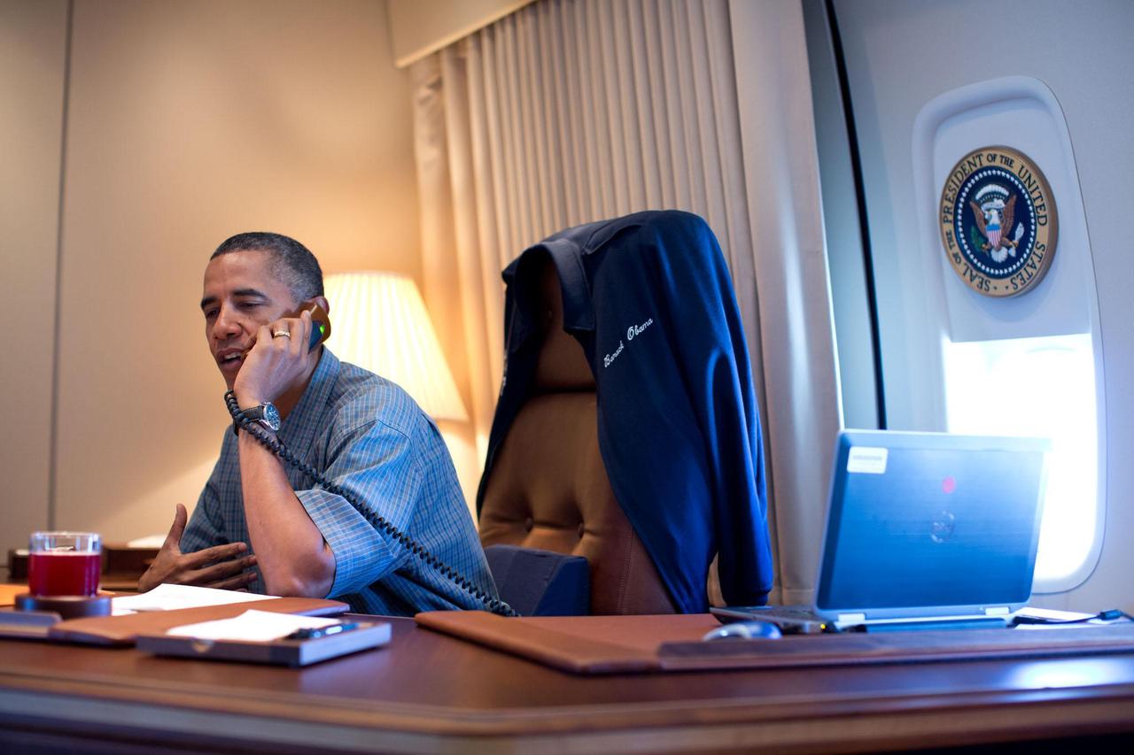 President Barack Obama talks on the phone with NASA Curiosity Mars rover team aboard Air Force One during a flight to Offutt Air Force Base in Nebraska, Aug. 13, 2012. Official White House Photo by Pete Souza