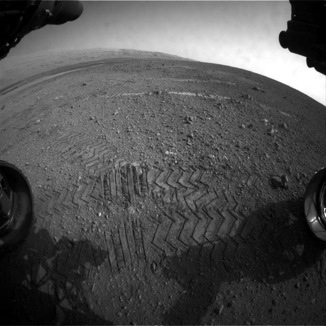 This image taken by a front Hazard-Avoidance camera on NASA Curiosity shows track marks from the rover first Martian drives.