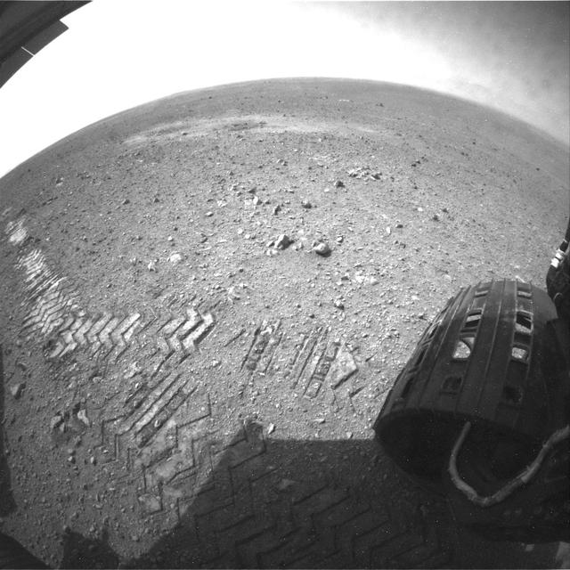 This image shows a close-up of track marks left by NASA Curiosity rover. Holes in the rover wheels, seen here in this view, leave imprints in the tracks that can be used to help the rover drive more accurately. The imprint is Morse code for JPL.