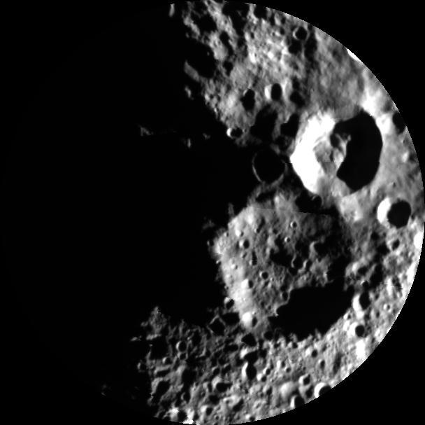This image from NASA Dawn mission reveals the creeping dawn over the north pole of the giant asteroid Vesta now that sunlight is shining over that area. The mosaic shows two large impact craters.