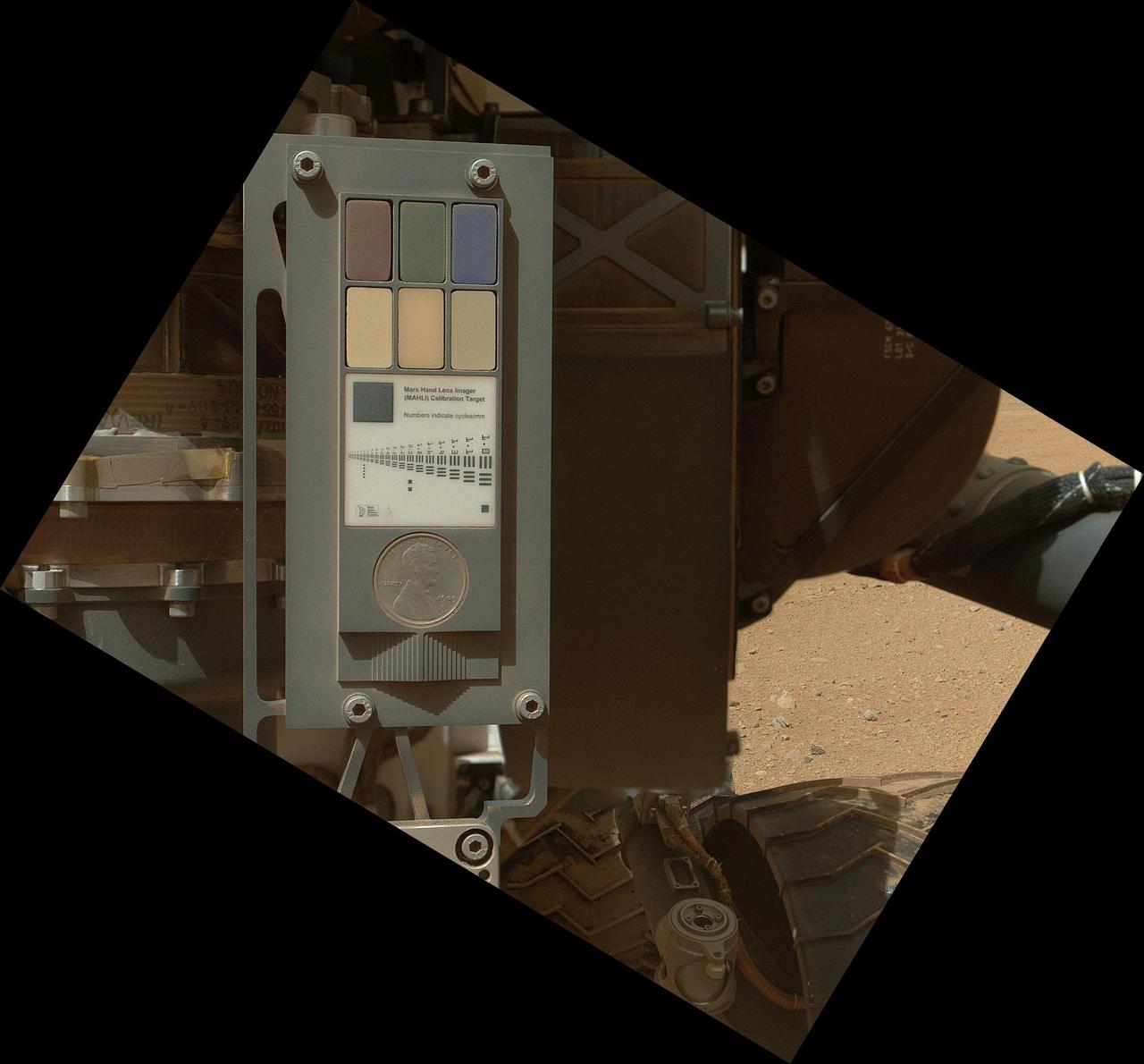 This view of the calibration target for the MAHLI camera aboard NASA Mars rover Curiosity combines two images taken by that camera during Sept. 9, 2012. Part of Curiosity left-front and center wheels and a patch of Martian ground are also visible.