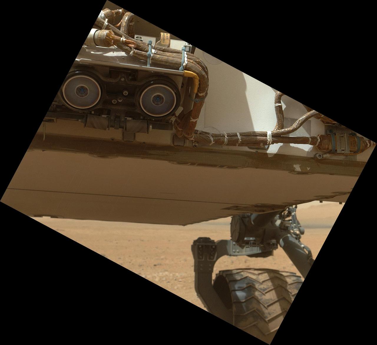 This view of the lower front and underbelly areas of NASA Mars rover Curiosity was taken by the rover MAHLI camera during Sept. 9, 2012. Also visible are the hazard avoidance cameras on the front of the rover.