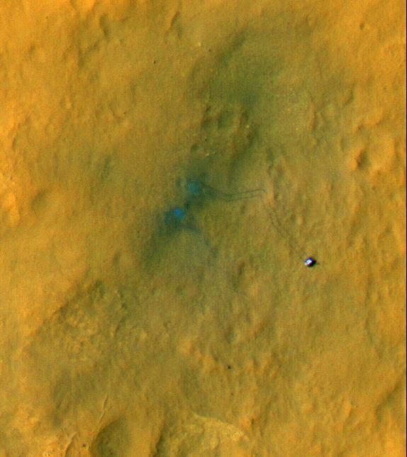 Tracks from the first drives of NASA Curiosity rover are visible in this image captured by the High-Resolution Imaging Science Experiment HiRISE camera on NASA Mars Reconnaissance Orbiter. The rover is seen where the tracks end.
