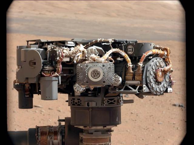 This image shows the Alpha Particle X-Ray Spectrometer APXS on NASA Curiosity rover, with the Martian landscape in the background. This image let researchers know that the APXS instrument had not become caked with dust during Curiosity landing.