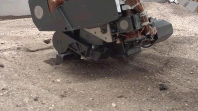 This image shows a test using an engineering model of the soil scoop for NASA Mars rover Curiosity. The scoop dips to about 1.4 inches 3.5 centimeters deep. This test took place at NASA Jet Propulsion Laboratory, Pasadena , Calif., in 2011.