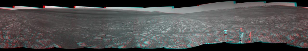 On the horizon in the right half of this panoramic view from NASA Opportunity is an area of Mars informally named Matijevic Hill, in commemoration of an influential rover-team leader. The hill includes an outcrop called Kirkwood.