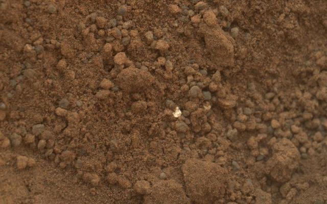 The mission science team assessed the bright particles in this scooped pit to be native Martian material rather than spacecraft debris as seen in this image from NASA Mars rover Curiosity as it collected its second scoop of Martian soil.
