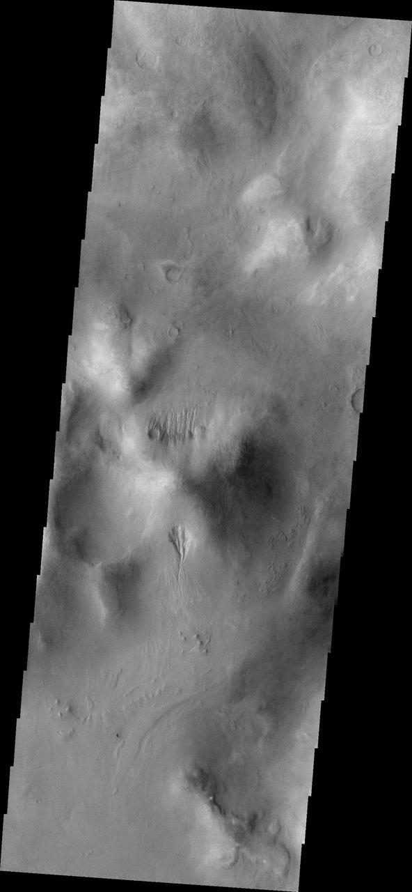 Small gullies captured in this image from NASA 2001 Mars Odyssey are located on the north and south sides of this hill. The hill is part of the mountainous region that borders the northeastern side of Argyre Planitia.