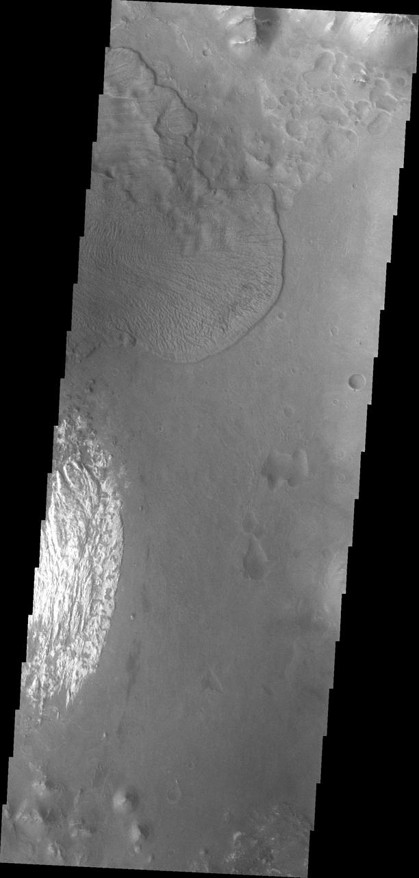 This image captured by NASA 2001 Mars Odyssey spacecraft shows a landslide deposit which flowed towards the floor of Ganges Chasma.