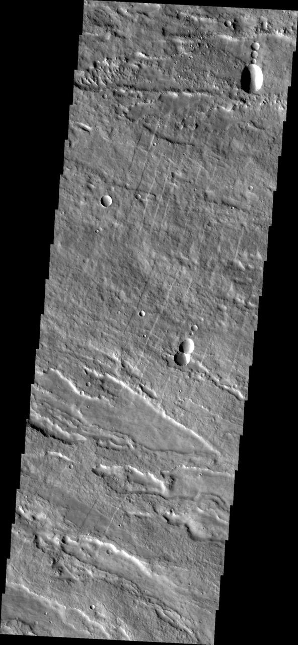 Image captured by NASA 2001 Mars Odyssey spacecraft shows the eastern flank of Arsia Mons midway between the summit of the volcano and the surrounding plains.