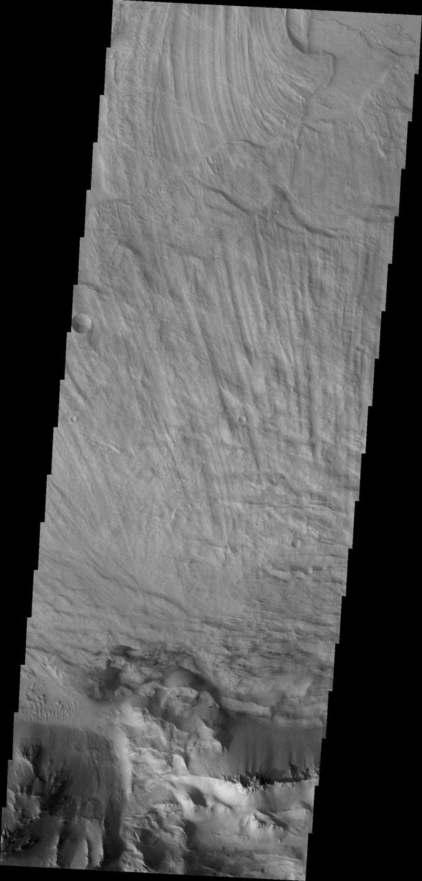 The finely ridged material in this image captured by NASA 2001 Mars Odyssey spacecraft are huge landslide deposits called Coprates Labes. These landslide deposits are located on the floor of Coprates Chasma.