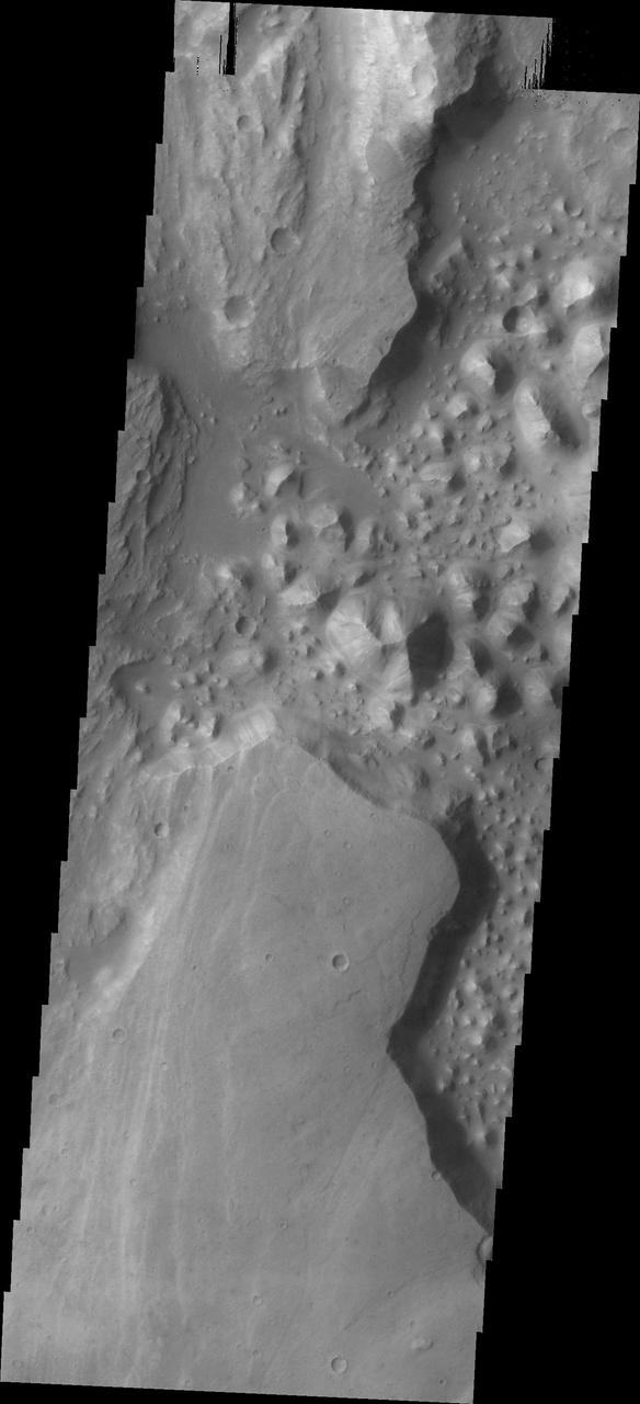 The hills chaos in this image from NASA 2001 Mars Odyssey spacecraft are located between Stege Crater, just outside of the image to the northeast, and Maja Valles left side of image.