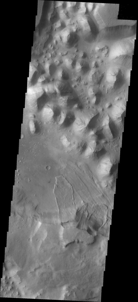 The landslide deposits in this image captured by NASA 2001 Mars Odyssey spacecraft are located in Baetis Chaos.