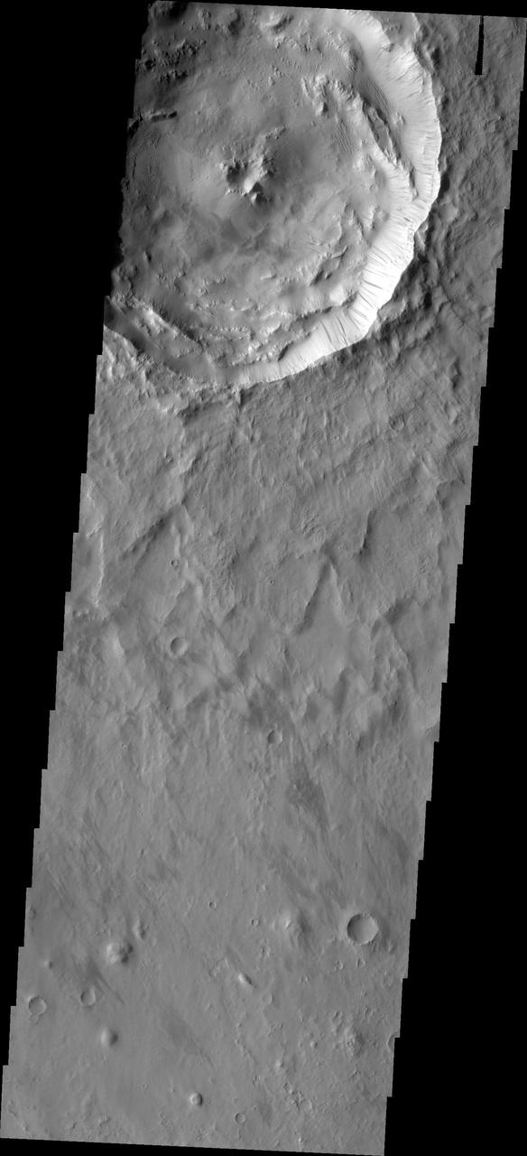 Dark slope streaks mark the rim of this unnamed crater as seen by NASA 2001 Mars Odyssey spacecraft.