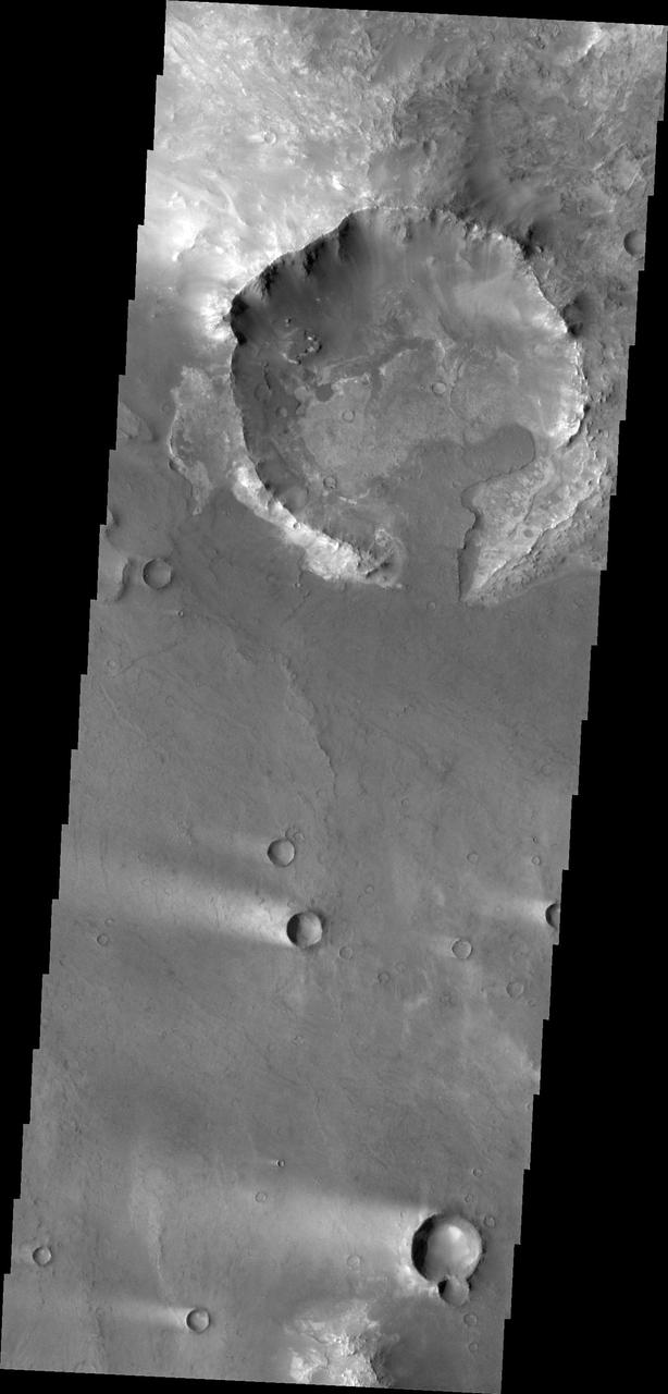 This image from NASA 2001 Mars Odyssey spacecraft shows a portion of northeastern Syrtis Major. In this image are several windstreaks and a lava flow that has entered the crater on the top of the image.