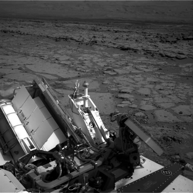 The NASA Mars rover Curiosity used its left Navigation Camera to record this view of the step down into a shallow depression called Yellowknife Bay. The descent into the basin crossed a step about 2 feet high, visible in the upper half of this image.