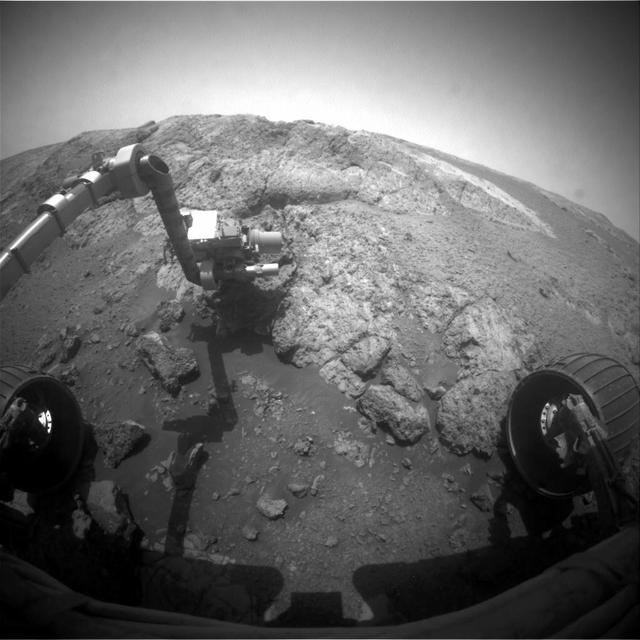 This image from NASA Mars Exploration Rover Opportunity shows the rover arm extended for examination of a target called Onaping at the base of an outcrop called Copper Cliff in the Matijevic Hill area of the west rim of Endeavour Crater.