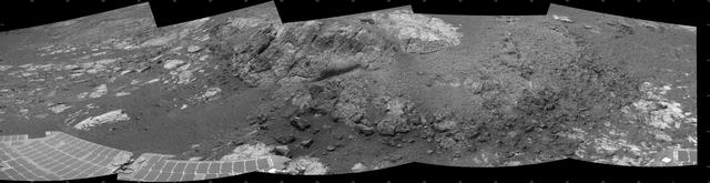 This 180-degree mosaic of images from the navigation camera on the NASA Mars Exploration Rover Opportunity shows the rover close to the outcrop called Copper Cliff, which is in the center of this scene.