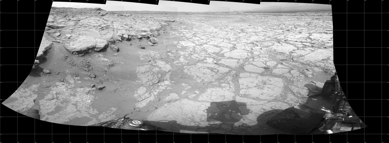 In a shallow depression called Yellowknife Bay, the NASA Mars rover Curiosity drove to an edge of the feature to record this view of the ledge at the margin and a view across the bay during the 130th Martian day, or sol, Dec. 17, 2012.