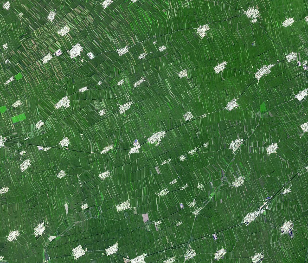 Acquired by NASA Terra spacecraft, this image shows Heilongjiang, a province of China located in the northeastern part of the country. Farms are small and long skinny rectangles in shape, surrounding regularly spaced villages.