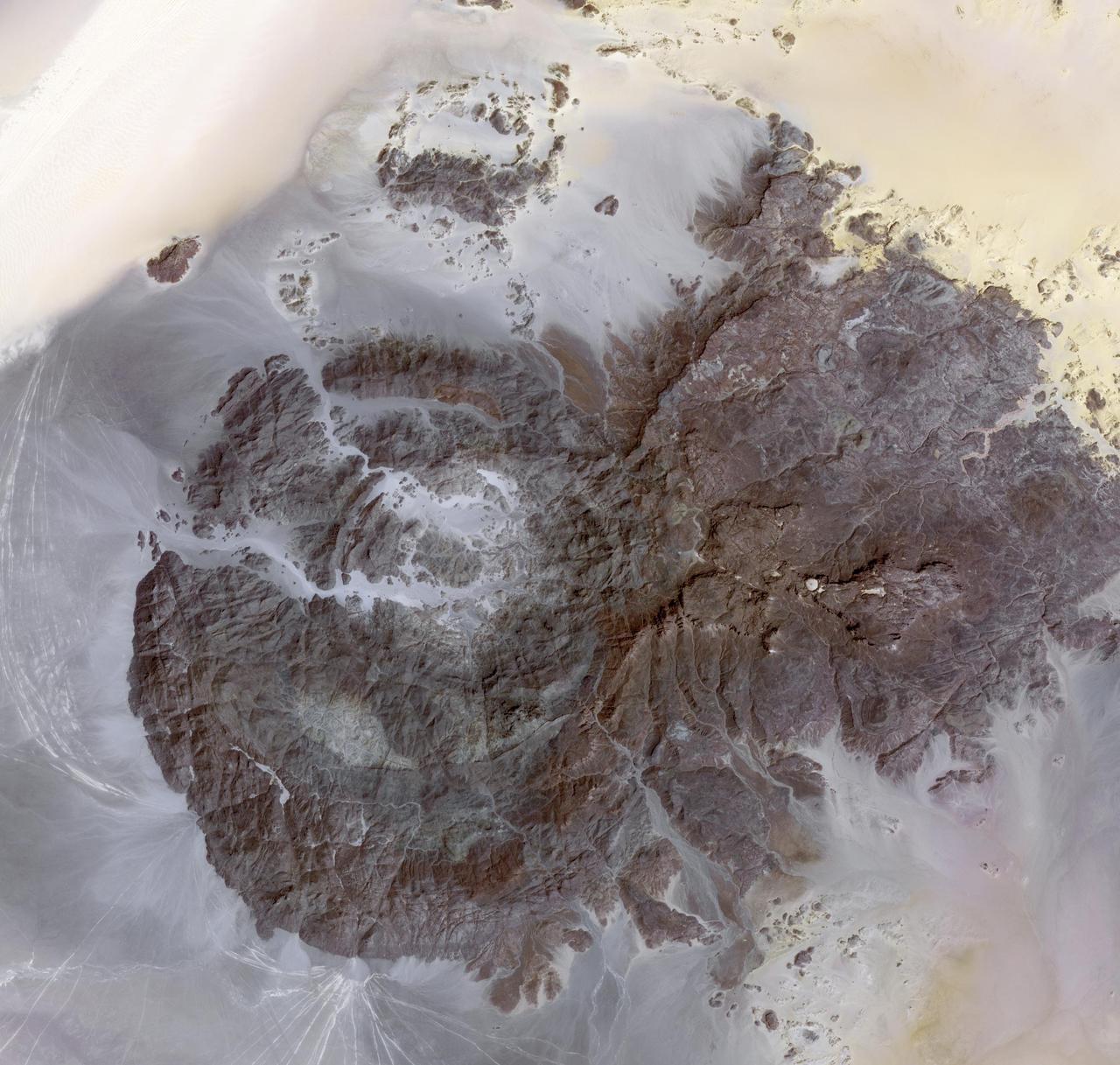 This image, acquired by NASA Terra spacecraft on Mar. 17, 2012, is of Jebel Uweinat, a mountain range in the area of the Egyptian-Sudanese-Libyan border. It is reportedly one of the driest places on earth.