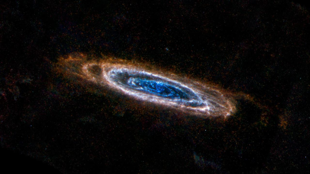 The ring-like swirls of dust filling the Andromeda galaxy stand out colorfully in this new image from the Herschel Space Observatory.