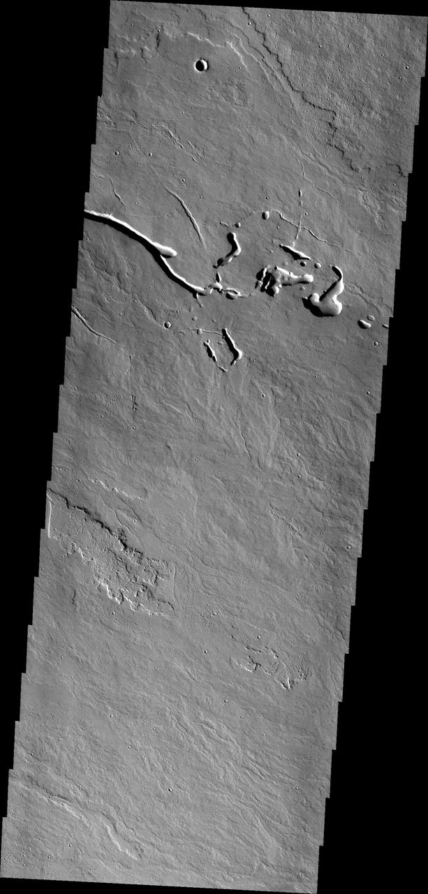The lava flows and collapse features in this image from NASA 2001 Mars Odyssey spacecraft are located near Ascraeus Mons.
