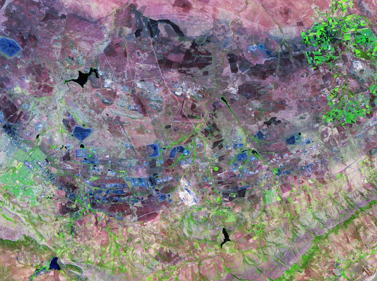 The Bushveld Igneous Complex BIC is a large layered igneous intrusion within the earth crust, exposed at the edge of the Transvaal Basin in South Africa. Numerous mines, tailings piles, and leach ponds are shown in blue.