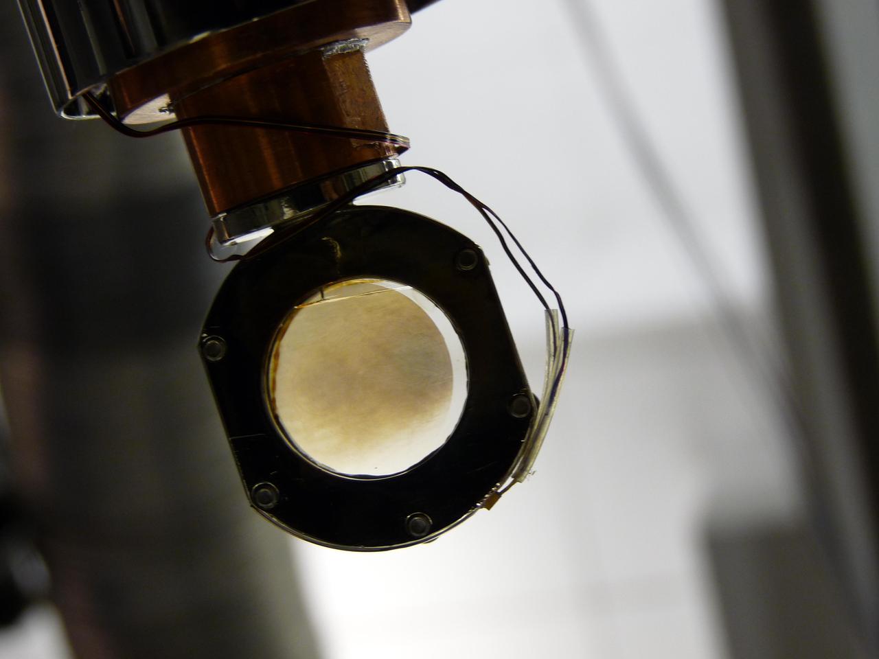 In a laboratory experiment at NASA Jet Propulsion Laboratory, Pasadena, Calif., scientists simulate the atmosphere of Saturn moon Titan. In this picture, molecules of dicyanoacetylene are seen on a special film on a sapphire window.