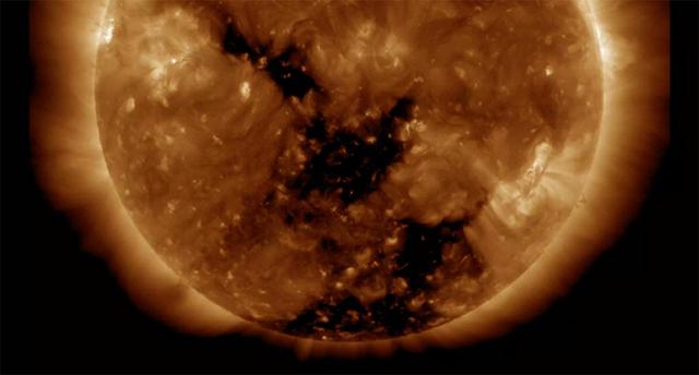 Two good-sized coronal holes have rotated around to the center of the sun where they will be spewing solar wind towards Earth (Nov. 8-9, 2016). Coronal holes are areas of open magnetic field from which solar wind particles stream into space. In this wavelength of extreme ultraviolet light they appear as the two dark areas at the center and lower portion of the sun. The stream of particles should reach Earth in a few days and are likely to generate aurora.  Videos are available at http://photojournal.jpl.nasa.gov/catalog/PIA16909