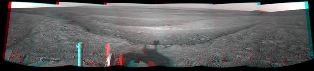 This 3-D view from the navigation camera on NASA Mars Exploration Rover Opportunity shows a vista across Endeavour Crater, with the rover own shadow in the foreground.