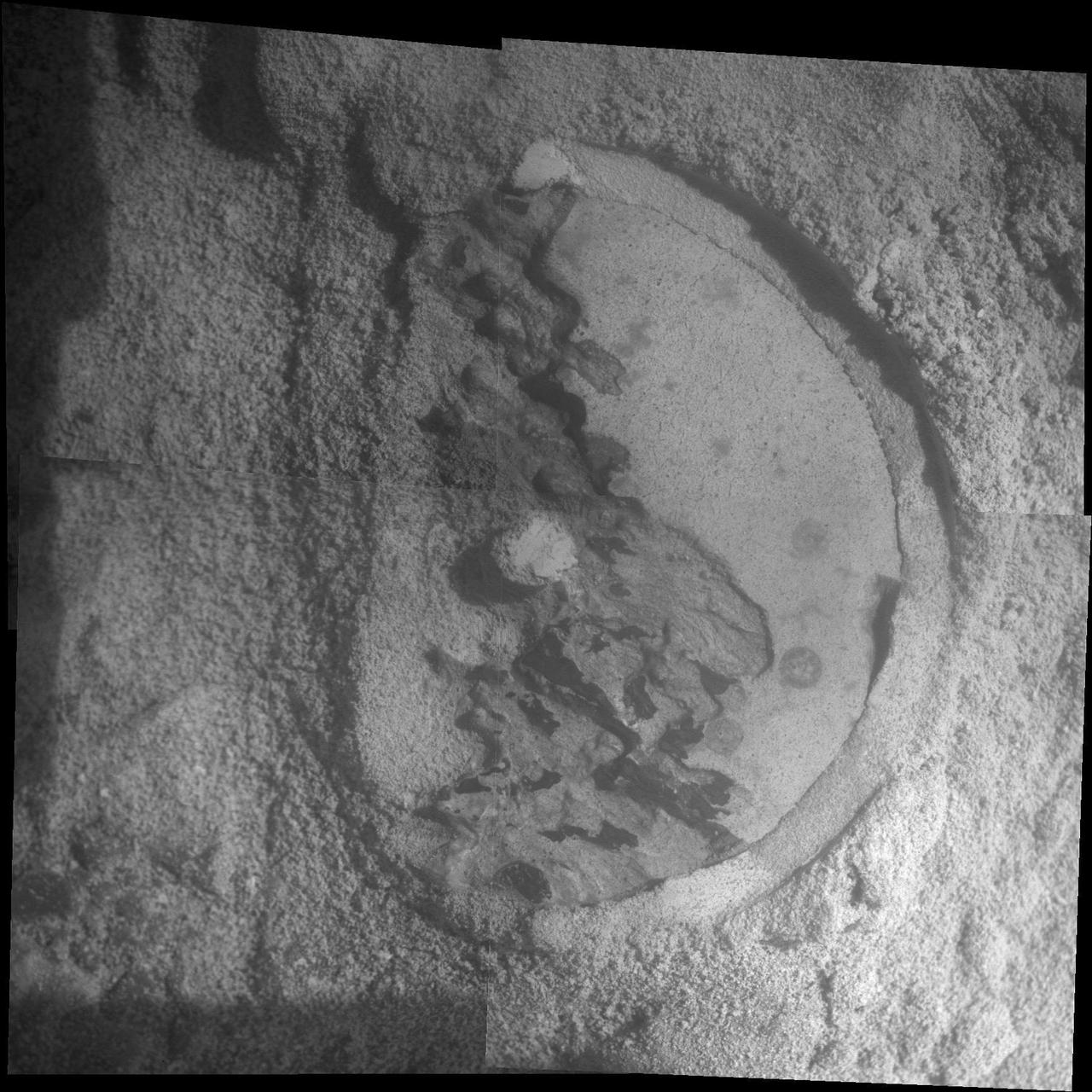 This mosaic shot by the microscopic imager on the robotic arm of NASA Mars Exploration Rover Opportunity shows a rock target called Esperance after some of the rock surface had been removed by Opportunity rock abrasion tool.