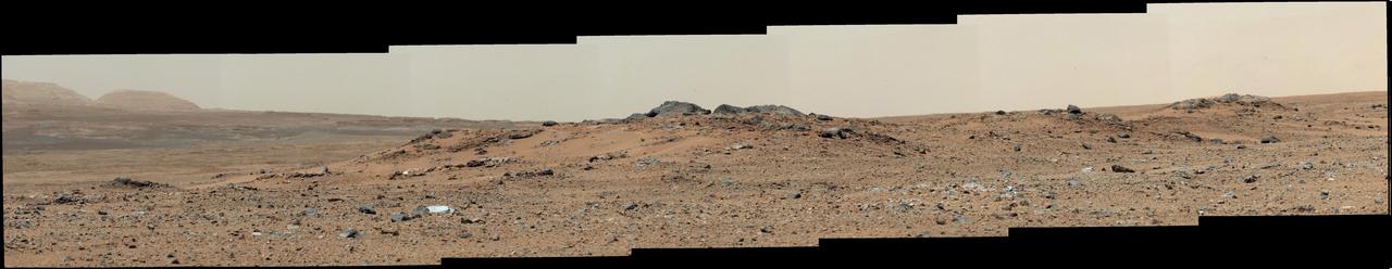 A rise topped by two gray rocks near the center of the scene is informally named Twin Cairns Island as seen by NASA Mars rover Curiosity. The center of the scene is toward the southwest.