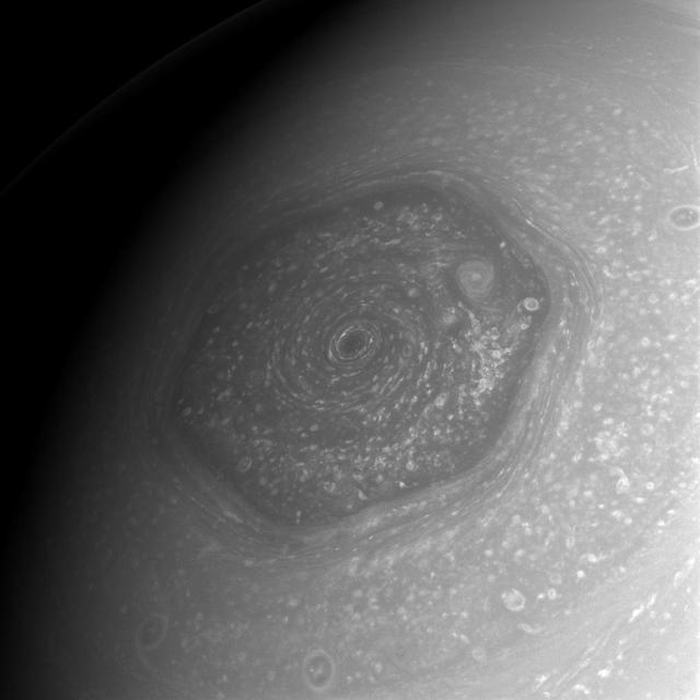 The area within Saturn north polar hexagon is shown by NASA Cassini spacecraft to contain myriad storms of various sizes, not the least of which is the remarkable and imposing vortex situated over the planet north pole.