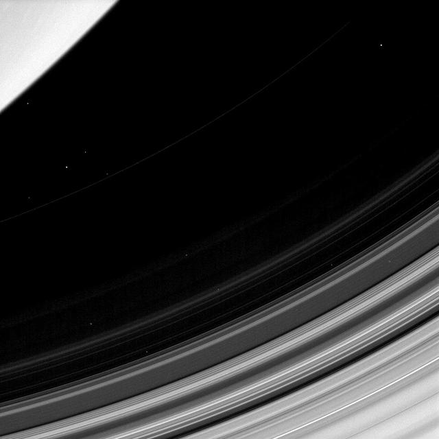 Saturn D ring is easy to overlook since it trapped between the brighter C ring and the planet itself. In this view from NASA Cassini spacecraft, all that can be seen of the D ring is the faint and narrow arc as it stretches from top right of the ima