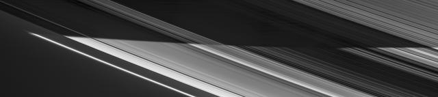 Saturn's shadow sweeps across the rings in a view captured on Nov. 5, 2006 by NASA's Cassini spacecraft. In the bottom half of the image, the countless icy particles that make up the rings bask in full daylight. In the top half, they move through Saturn's shadow. On the right side of the image, the planet's night side, dimly lit by reflected ringshine, can be seen through gaps in the darkened rings.  This view is a mosaic of four visible light images taken with Cassini's narrow-angle camera at a distance of approximately 932,000 miles (1.5 million kilometers) from Saturn.  The Cassini spacecraft ended its mission on Sept. 15, 2017.  https://photojournal.jpl.nasa.gov/catalog/PIA17199