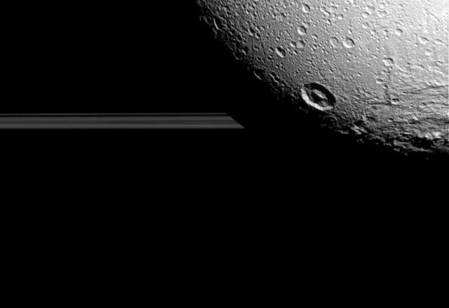 Saturn moon Dione hangs in front of Saturn rings in this view taken by NASA Cassini spacecraft during the inbound leg of its last close flyby of the icy moon.