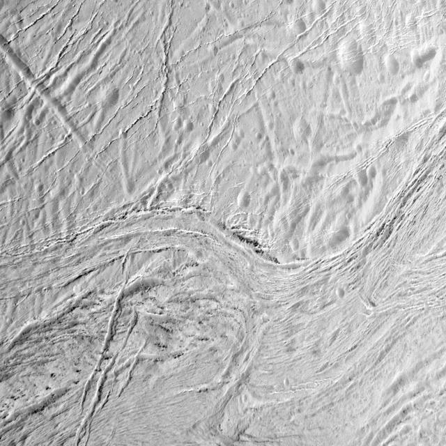 During its final close flyby of Saturn moon Enceladus, NASA Cassini orbiter shows this view featuring the nearly parallel furrows and ridges of the feature named Samarkand Sulci.