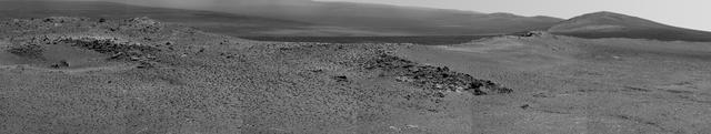 NASA Opportunity used its Pancam to record this view of the rise in the foreground, called Nobbys Head. This view is centered toward the south-southeast, with Opportunity next destination, Solander Point, toward the right edge of the view.