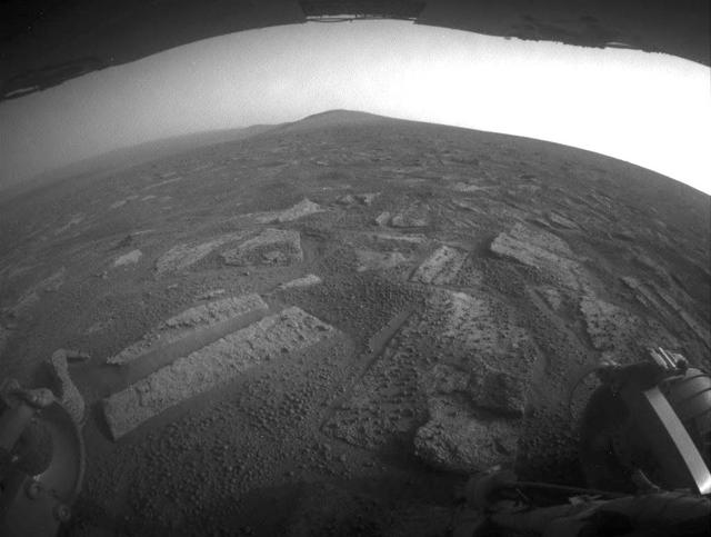 This view shows the terrain that NASA Mars Exploration Rover Opportunity is crossing in a flat area called Botany Bay on the way toward Solander Point, which is visible on the horizon.